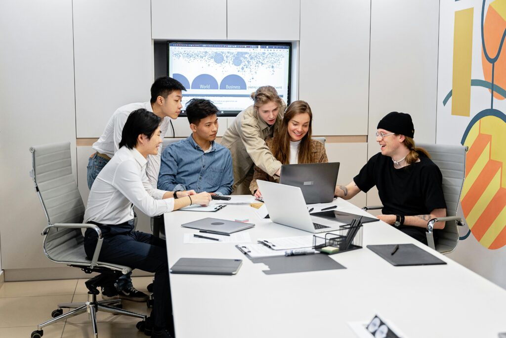A diverse team of professionals engaged in a collaborative meeting inside a modern office setting.